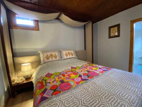 1 dormitorio con 1 cama grande con una manta colorida en İznik Göl Manzaralı Ev, 