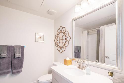 a white bathroom with a sink and a mirror at Loft with Views-King Beds-Shop & Dine-1mi & Parking 4058 in Phoenix