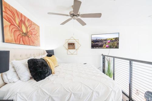 a bedroom with a white bed with a ceiling fan at Loft with Views-King Beds-Shop & Dine-1mi & Parking 4058 in Phoenix