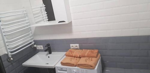 a bathroom with a sink with towels on it at Верховина in Uzhhorod