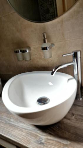 a white sink sitting on a counter in a bathroom at NEO resort jezero Bruje in Erdevik