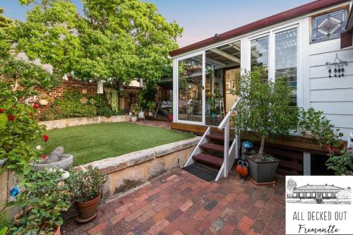 a house with a lawn in the front yard at All Decked Out, Fremantle in Fremantle