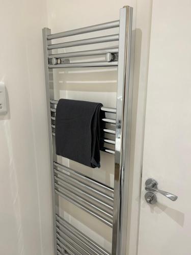 a towel is hanging on a towel rack in a bathroom at Hackney Apartment in London
