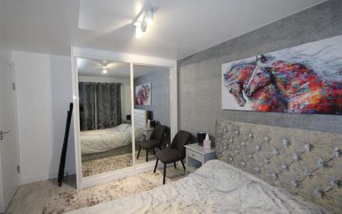 a bedroom with a bed and a mirror at Modern newly decorated 25 Min from City of London in London