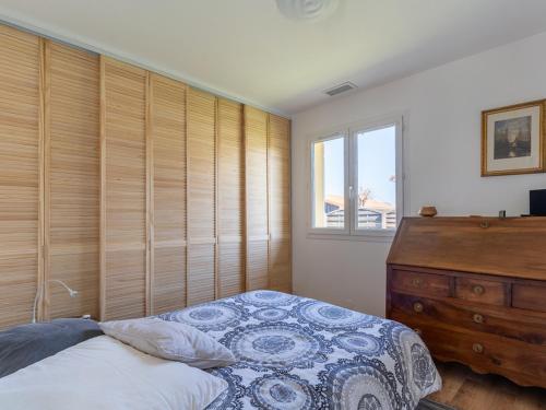 a bedroom with a bed and a dresser and a window at Maison à Mimizan avec jardin et piscine privée pour 6 personnes - FR-1-50-95 in Mimizan