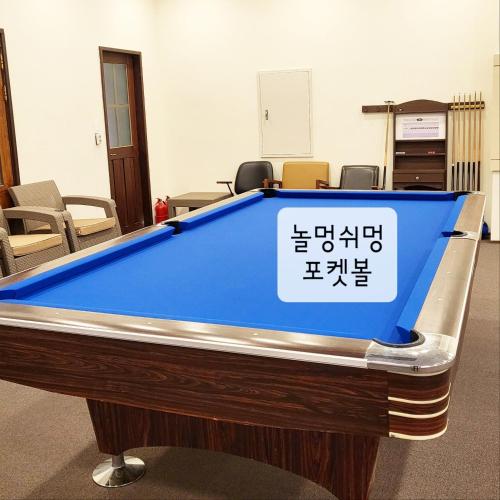 a pool table in a room with a sign on it at Olle Resort in Jeju