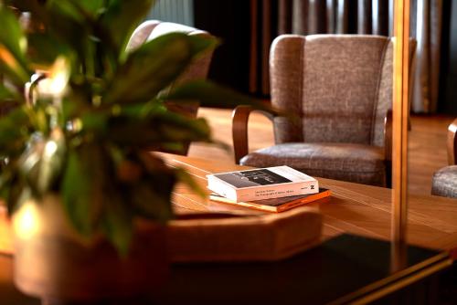 a book sitting on a table next to a chair at High Country Motor Lodge - Near NAU and Downtown in Flagstaff
