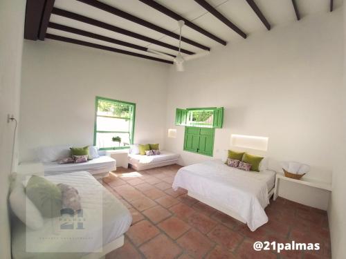 a white room with two beds and a couch at Casa Fortuna, piscina privada, 4 hab/4 baños I Villa en Honda in Honda
