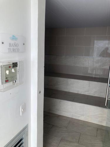 a bathroom with a shower with a tile floor at Marina Club Piso 8 in Cartagena de Indias