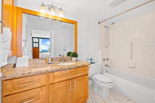 a bathroom with a sink and a tub and a toilet at 1BR with Stunning Ocean Views, Near Beach & Parking in Honolulu