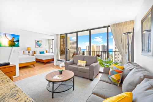 a living room with a couch and a bed at 1BR with Stunning Ocean Views, Near Beach & Parking in Honolulu