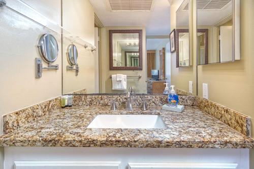 a bathroom with a sink and a large mirror at Oceanfront Condo & Walking Distance to Beach and Town- Hale Kona Kai 207 by Casago Kona in Kailua-Kona