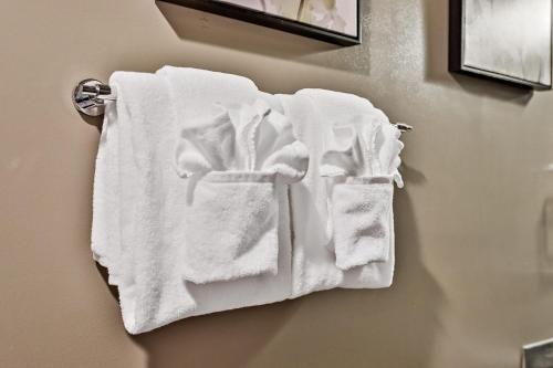 a group of white towels hanging on a wall at The Versailles by Samsara Resort Top Luxury Top View 1300SQF 2BEDROOM 2BATHROM in Canmore