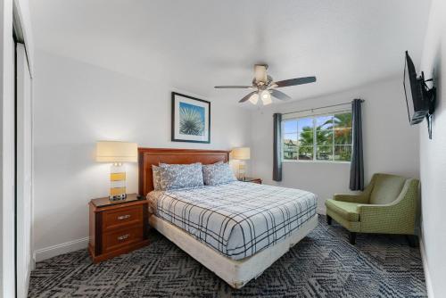 a bedroom with a bed and a chair and a ceiling fan at Coolidge 3bd 2ba upgraded apartment with amenities in Coolidge