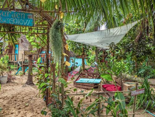 a resort with a hammock and a resort at Yellow Sun Kampot in Kampot