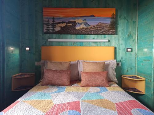 a bedroom with a bed with a colorful quilt at Cliff House Gran Canaria in Gáldar