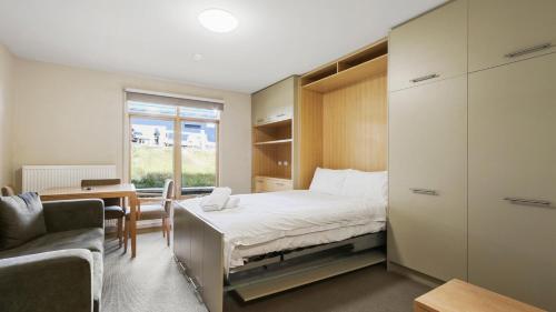 a bedroom with a bed and a desk and a chair at Chalet Hotham 7 in Mount Hotham