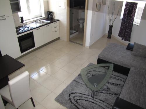 a kitchen with a table and a counter top at Apartments Marina in Zadar