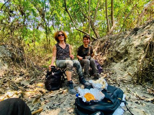 a woman and a boy sitting on a trail with a backpack at Bardia Wild Side Hotel in Bhurkīā