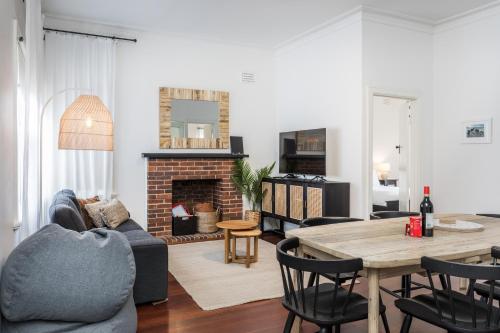 a living room with a table and a fireplace at Karraleen at Middleton in Albany