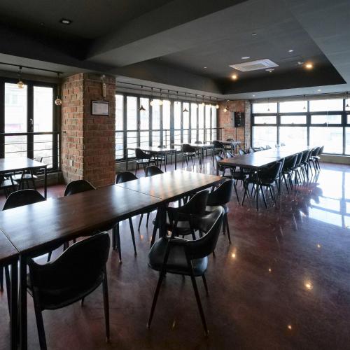a dining room with tables and chairs and windows at Residence Hotel K Okpo in Geoje 