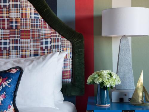 a bed with a white pillow and a lamp on a table at Graduate by Hilton Annapolis in Annapolis