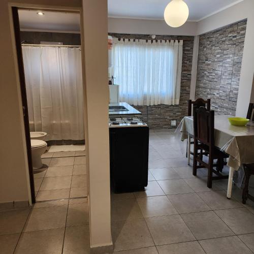 a kitchen and dining room with a table and a stove at La constancia in La Plata