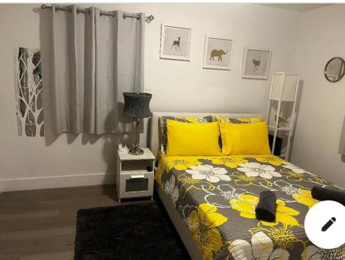 a bedroom with a bed with yellow pillows at Home Sweet Home in Miami