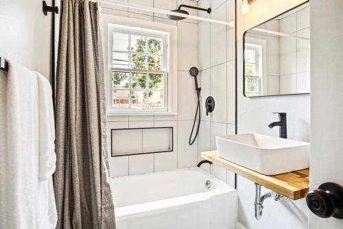 a white bathroom with a sink and a mirror at Chic 3br Haven Fully Furnished & Private Carpot in Oklahoma City