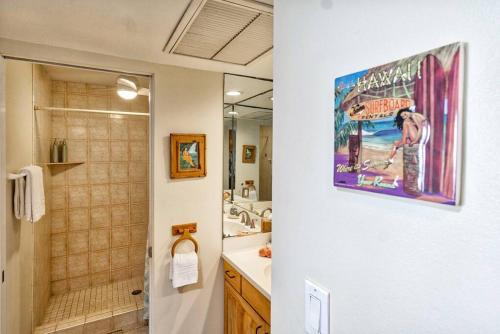 a bathroom with a shower and a sink and a mirror at Beautiful Oceanfront Condo! - Hale Kona Kai 303 in Kailua-Kona