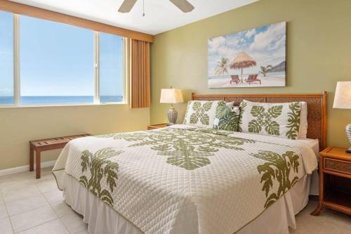 a bedroom with a bed and a large window at Beautiful Oceanfront Condo! - Hale Kona Kai 303 in Kailua-Kona