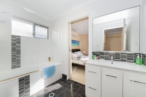 a bathroom with a sink and a mirror at Vibrant, Lovely 3BR Family Home in North Ward