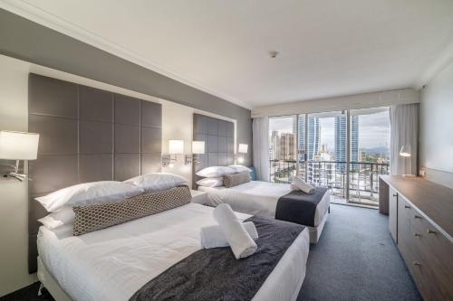 a hotel room with two beds and a balcony at Gorgeous Private Suite with Balcony in Gold Coast