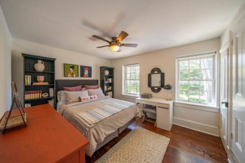 a bedroom with a bed and a ceiling fan at The Walton House - historic 3bd 2 5ba with parking in Kennett Square