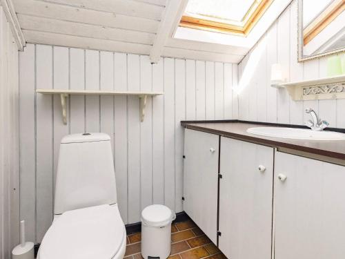 a bathroom with a toilet and a sink at Holiday home Stubbekøbing III in Stubbekøbing