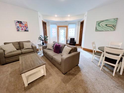 a living room with a couch and a table at 2BR Balcony Suite with Parking at The Grand Castle in Grandville