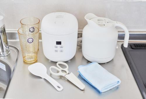 a counter with a blender and other appliances on it at Yuzuki Dome Osaka Kujo in Osaka