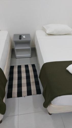 a bedroom with a bed with a nightstand next to it at Casa de Mia in Asuncion