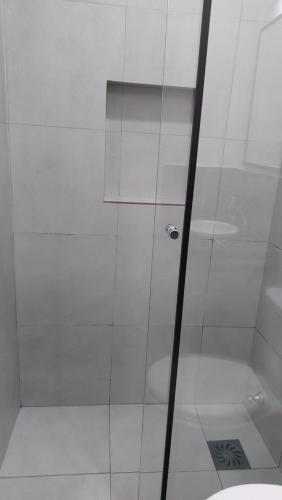 a shower with a glass door next to a toilet at Casa de Mia in Asuncion