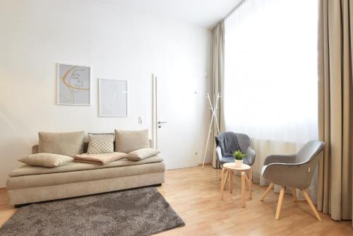 a living room with a couch and a table at Hidden Gem in Central Innsbruck with free Parking in Innsbruck