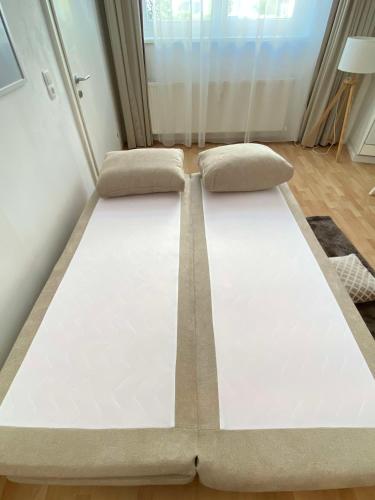 a bed in a room with two pillows at Hidden Gem in Central Innsbruck with free Parking in Innsbruck