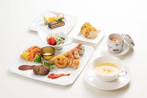 a table with plates of food and a cup of tea at Urari Takeo Garden Terrace Spa Resorts in Takeo