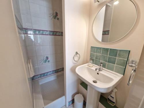 a bathroom with a sink and a shower with a mirror at Appartement avec Piscine, Tennis & Balcon, Centre-ville Chatelaillon-Plage, 6 Pers, 2 Ch - FR-1-706-17 in Châtelaillon-Plage