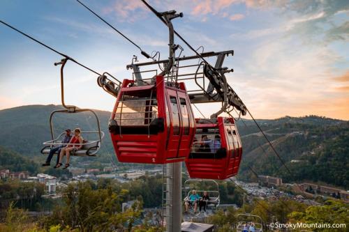 two people riding a gondola on a ski lift at Rustic Modern Getaway - Mtn View - Creek - Hammock - Rest in Sevierville