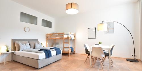 - une chambre avec un lit, une table et des chaises dans l'établissement Super central city appartement with free parking, à Innsbruck