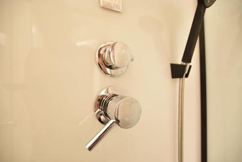 a silver door handle on a white door at Super central city appartement with free parking in Innsbruck