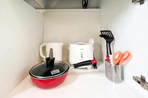 a kitchen counter with a tea pot and utensils at Trioni EBISU in Osaka
