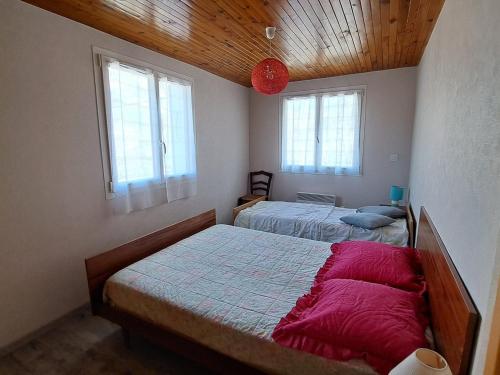 une chambre avec deux lits et deux fenêtres dans l'établissement Beau T3 à Jausiers avec terrasse et parking - FR-1-165A-176, à Jausiers