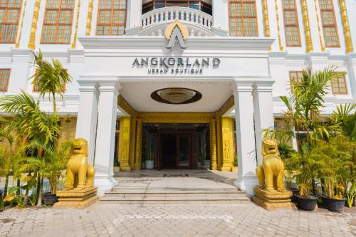 a building with two statues in front of it at Angkor Land Urban Boutique in Siem Reap