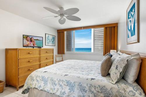 a bedroom with a bed and a dresser and a window at Dreamy True Oceanfront Condo - Hale Kona Kai 307 by Casago Kona in Kailua-Kona